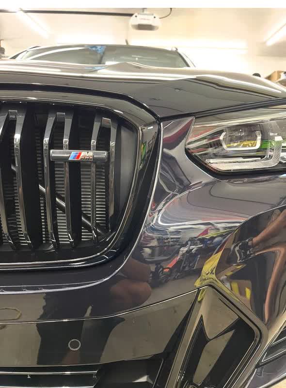 Studio-lit high-performance vehicle in a dark showroom